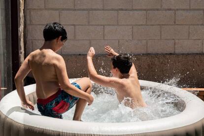 Niños jugando en una piscina hinchable. 