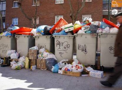Las basuras se acumulan en varios contenedores de la calle de San Dámaso, al lado del Manzanares.