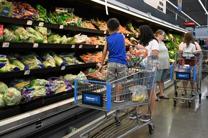 Consumers shop in the produce section of a Walmart store in Burbank, California on August 15, 2022.