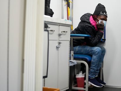 A woman sits before being treated inside a Baltimore City Health Department RV, Monday, March 20, 2023, in Baltimore.