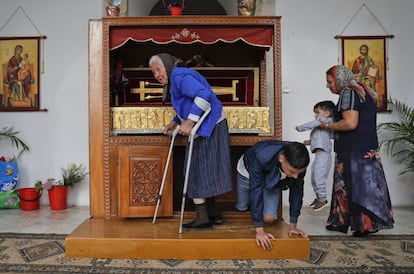 Cada año, miles de gitanos festejan el Día Nacional de los Gitanos, una costumbre con más de 200 años de historia. En la imagen, una mujer de avanzada edad toca los restos de un supuesto santo, en Valcea (Rumanía).