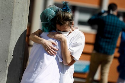 Two health workers hug outside the Severo Ochoa hospital in Madrid in March.