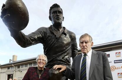 Colin Meads posa con una estatua suya en el mes de junio. 