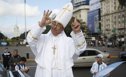 Un aficionado argentino, disfrazado de papa Francisco, hace gestos a la cámara indicando que el partido terminará 1-0 en favor de Argentina.