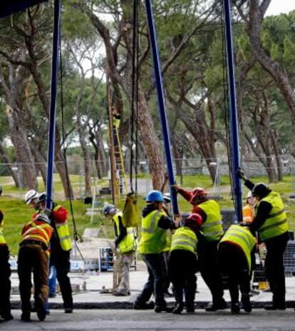 Los operarios apuntalan los postes.