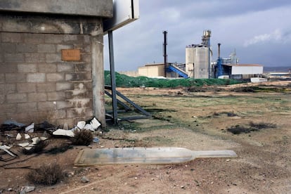 In this Tuesday, Jan. 26, 2016 photo, a broken sign lies on the ground at the Phoenicia Glass Works Ltd. factory in the southern Israeli town of Yeruham. Phoenicia Glass Works Ltd. produces a million bottles and containers a day for beverage giants Coca Cola, Pepsi, and Heineken, as well as Israeli wineries and olive oil companies. Every day, about 300,000 bottles come out of the ovens with defects. (AP Photo/Oded Balilty)