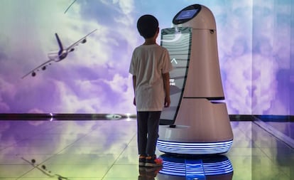 Un niño se  comunica con un robot en el aeropuerto internacional de Incheon, en Seúl. 