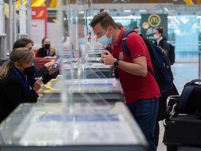 A passenger checks in at Madrid's Barajas Airport in March 2021.