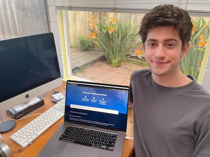 Avi Schiffmann, de 19 años, posa junto a la portada de 'Ukraine Take Shelter' en su habitación, en San Diego (California, Estados Unidos).