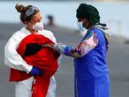 A nurse holds a newborn baby next to her mother, in the port of Arguineguin, in the southern part of the island of Gran Canaria, Spain April 30, 2021. REUTERS/Borja Suarez