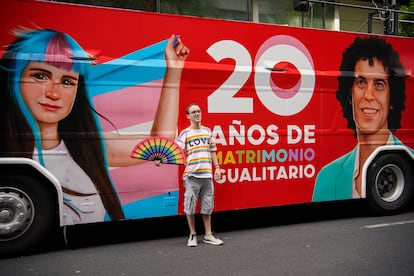 Un joven junto a una de las carrozas que participan en el desfile del Orgullo en Madrid, este sábado. 