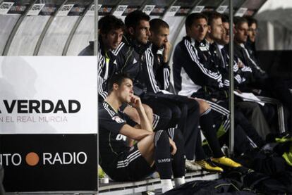 Cristiano Ronaldo (abajo) y Benzema (el tercero por la izquierda), en el banquillo.