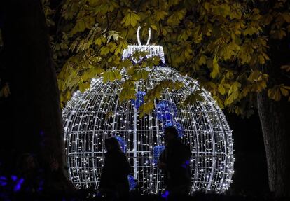 El ‘bosque de las hadas’, la ‘vía láctea’, la ‘rotonda de los corazones’ y la ‘alameda de los deseos’ (donde los visitantes pueden anudar anhelos para 2020), conforman la nueva decoración del parque del centro de Madrid. En la imagen, una bola de Navidad gigante conformado por pequeñas luces.