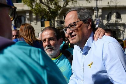 Catalan regional president Quim Torra (R) greets people upon his arrival to the march.