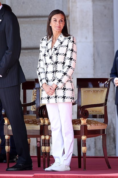En la imagen, Letizia Ortiz con zapatillas planas blancas combinadas con americana y pantalón blanco. 