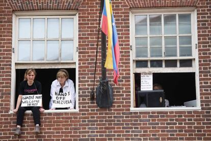 Acivistas con carteles contra el líder de la oposición venezolana Juan Guaidó. 