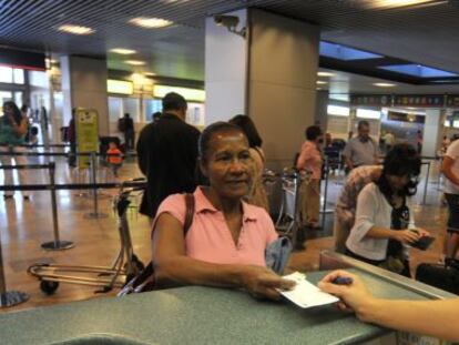 An Ecuadorian immigrant prepares to fly home from Spain after losing her job. 