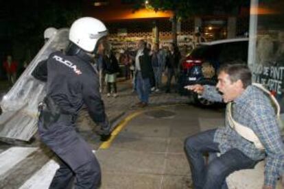 Un Policía Nacional carga contra un manifestante durante los disturbios tras la manifestación de los trabajadores de los astilleros de Navantia a las puertas de un hotel en El Ferrol, donde el PPlocal celebraba el inicio de campaña electoral gallega.