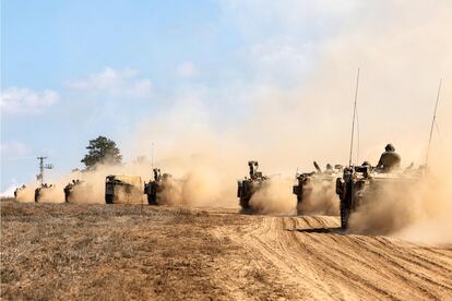 Israeli army tanks and vehicles deploy along the border with the Gaza Strip in southern Israel on October 13, 2023. 