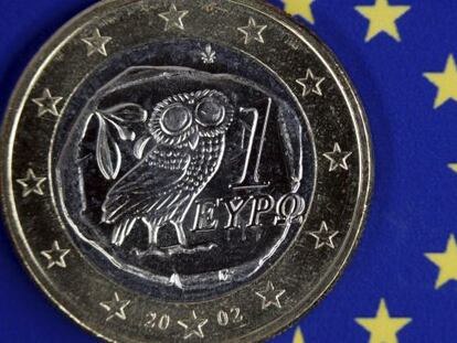 Una moneda de euro griego permanece sobre el emblema de la Uni&oacute;n Europea. 