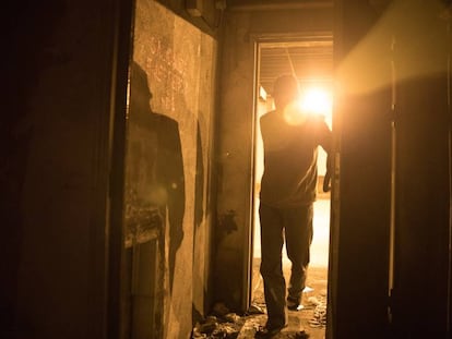 A homeless person sleeps by the emergency exits in the Azca tunnels.