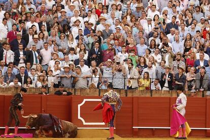 El público toma imágenes del quinto toro de la tarde, del diestro José María Manzanares, en la corrida del Domingo de Resurreción celebrada en la Real Maestranza de Sevilla.