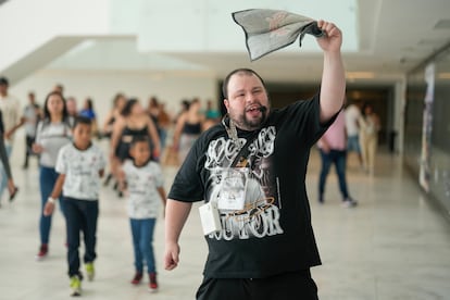 Luis Butti, a guide with autism spectrum disorder leads a tour group at the Corinthians soccer club Neo Quimica Arena in Sao Paulo, Brazil