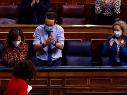 El presidente del Gobierno, Pedro Sánchez (izquierda), la vicepresidenta primera, Carmen Calvo, el vicepresidente Pablo Iglesias y la vicepresidenta y ministra de Economía, Nadia Calviño (derecha) aplauden a la ministra de Hacienda, María Jesús Montero (abajo) tras su intervención durante el Pleno del Congreso.