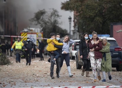 Members of the public leave the site of the explosion in Madrid today.