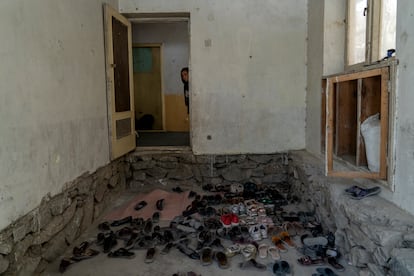 Afghan girl looks out the door of an underground school, in Kabul, Afghanistan, Thursday, July 28, 2022.