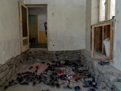 Afghan girl looks out the door of an underground school, in Kabul, Afghanistan, Thursday, July 28, 2022.