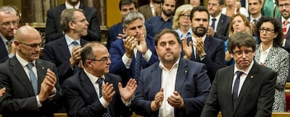 El presidente de la Generalitat, Carles Puigdemont (c) tras su discurso ante el pleno del Parlament donde esta tarde compareció para explicar la situación política.