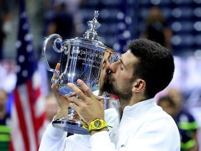 Serbia's Novak Djokovic celebrates with the trophy after winning the U.S. Open.