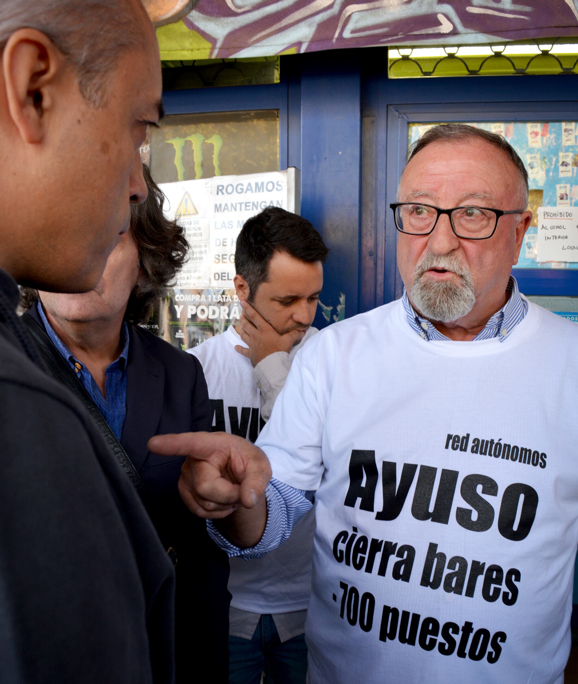 García negocia con el vocero de la empresa Metro para aplazar el desalojo de su local de frutos secos en Aluche.