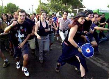 Un grupo de asistentes al Festival de Benicàssim, a la carrera para ocupar la primera fila frente al escenario.