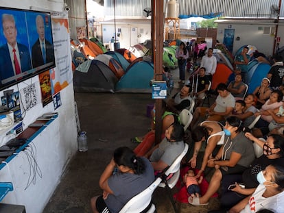 Migrantes observan el debate entre Joe Biden y Donald Trump, desde un refugio para migrantes que esperan solicitar asilo, en Tijuana, (México) el 27 de junio de 2024.