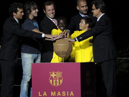 Guillermo Amor, primer residente de La Masia; Carles Puyol, capitán del Barcelona; Sandro Rosell, presidente, Pep Guardiola, técnico; dos canteranos y Artur Mas, presidente de la Generalitat, en la inauguración.