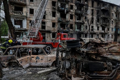 Rescuers work at a site of a residential building heavily damaged by a Russian missile strike