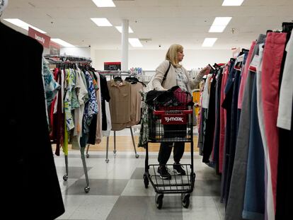 A customer checks prices while shopping at a retail store in Vernon Hills