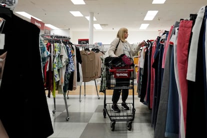 A customer checks prices while shopping at a retail store in Vernon Hills