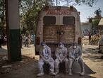 Exhausted workers, who bring dead bodies for cremation, sit on the rear step of an ambulance inside a crematorium, in New Delhi, India, Saturday, April 24, 2021. As India suffers a bigger, more infectious second wave with a caseload of more than 300,000 new cases a day, the country’s healthcare workers are bearing the brunt of the disaster. (AP Photo/Altaf Qadri)