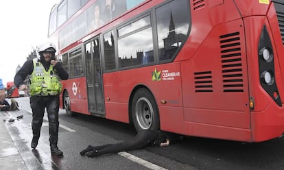 Una mujer herida yace en el suelo después del atentado en el puente de Westminster, en Londres.