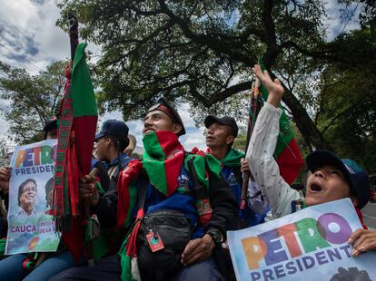 Miembros de la guardia indígena de Tacueyó, Cauca, saludan a la gente que mira la Caravana desde la capota de una chiva cerca de la Neiva, Caldas, el 13 de Junio de 2022.