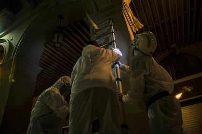 Members of the group use a ladder to remove the ribbons.