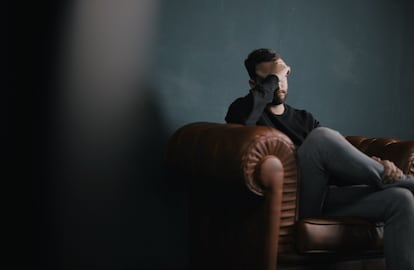 Un hombre se lamenta en un sillón.