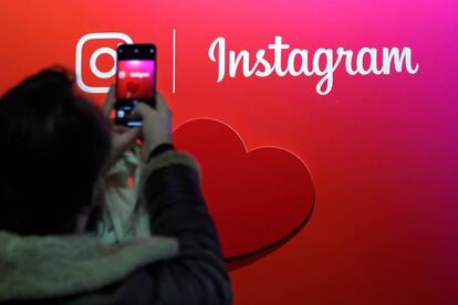 A visitor takes a picture of the Instagram application logo at the Young Entrepreneurs fair in Paris, France, February 7, 2018. REUTERS/Charles Platiau