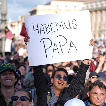 Faithful celebrate after white smoke appeared from the chimney of the Sistine Chapel where 133 cardinals gathered on the second day of the conclave to elect a successor to late Pope Francis, at the Vatican, Thursday, May 8, 2025. (AP Photo/Emilio Morenatti)
