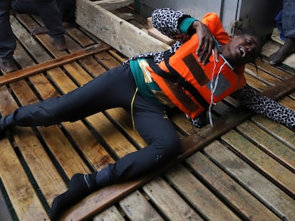 A migrant reacts aboard a Spanish NGO Proactiva Open Arms rescue boat, after being in the Mediterranean sea, Wednesday, Nov. 11, 2020. The Open Arms rescue ship had been searching for the boat in distress for hours before finally finding it Wednesday morning in international waters north of Libya. The NGO had just finished distributing life vests and masks to the passengers to begin transferring them to safety when the flimsy boat split in half throwing them into cold waters. (AP Photo/Sergi Camara)