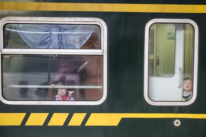 Unos niños juegan en un tren en la estación de Nanjin, China.