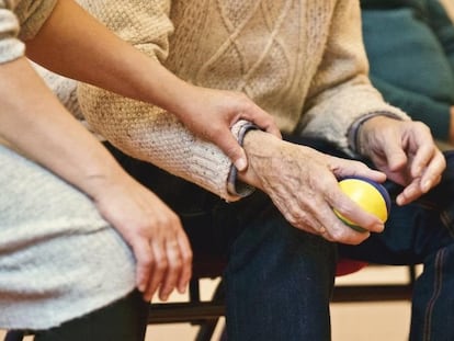 Una persona que sufre de párkinson hace ejercicio con una pelota de goma en la mano.